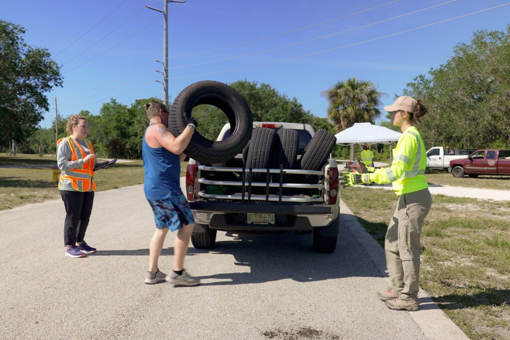 Image of a customer removing tires from their trailer during the County's free tire drop-off event on April 18, 2026.