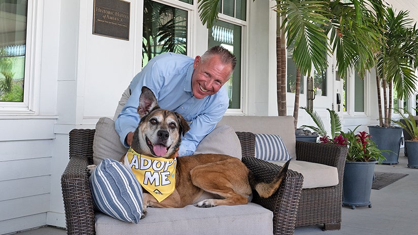 Pinellas County Commissioner Brian Scott posing with adoptable K-9 Lady from Pinellas County Animal Services.
