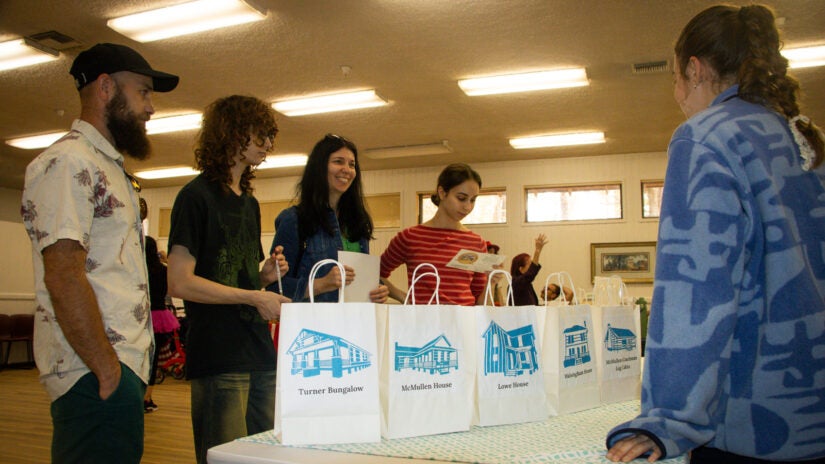 Young men and women vote for their favorite historic home at Heritage Village during the Preserved with Love event in March 2026.