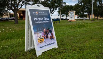 Yard sign for Pinellas Recovers in a yard in front of a help center.