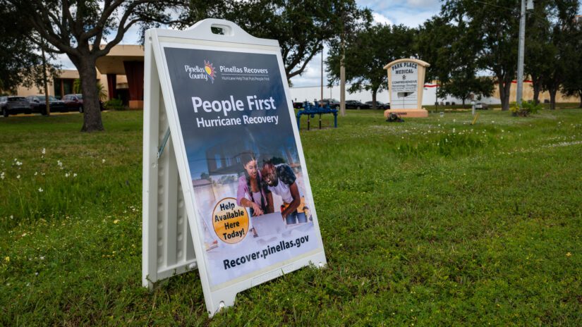 Yard sign for Pinellas Recovers in a yard in front of a help center.