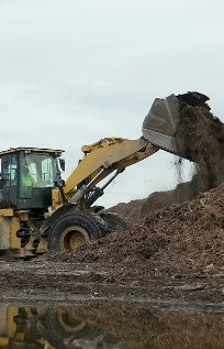 A front load tractor moves mulch at the Pinellas County Solid Waste facility.